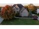 Spacious two-story brick home featuring mature trees and meticulous landscaping at 12372 Ostara Ct, Fishers, IN 46037