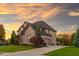 Lovely brick home with a spacious driveway, two-car garage and a basketball court at 12372 Ostara Ct, Fishers, IN 46037