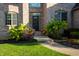 Charming brick home featuring an inviting front door with seasonal decorations and a well-manicured lawn at 12372 Ostara Ct, Fishers, IN 46037