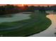 Sunrise aerial view of a golf course showcasing the manicured green, sand traps and surrounding trees at 12372 Ostara Ct, Fishers, IN 46037