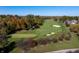 Aerial view of the golf course featuring lush greens, sand traps, and mature trees in a tranquil setting at 12372 Ostara Ct, Fishers, IN 46037