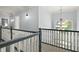 Upstairs hallway with carpet flooring, neutral walls, and attractive chandelier at 12372 Ostara Ct, Fishers, IN 46037