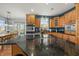 Spacious kitchen featuring granite countertops, stainless steel appliances, and wooden cabinetry at 12372 Ostara Ct, Fishers, IN 46037