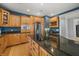 Well-equipped kitchen features wooden cabinetry, stainless steel appliances, and a center island with a granite countertop at 12372 Ostara Ct, Fishers, IN 46037