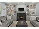 Cozy living room with fireplace, custom built-in shelves, and plush seating at 12372 Ostara Ct, Fishers, IN 46037