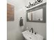 Stylish powder room featuring an elegant sink and decorative mirror at 12372 Ostara Ct, Fishers, IN 46037