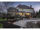 A backyard with a pool, a hot tub, a deck, and a patio at dusk offers luxurious outdoor living and entertaining at 12715 Norfolk Ln, Carmel, IN 46032