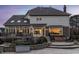 Backyard with deck, patio, hot tub, and lush landscaping during twilight at 12715 Norfolk Ln, Carmel, IN 46032