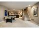 Spacious finished basement with carpet, pool table, and stairway to upper level at 12715 Norfolk Ln, Carmel, IN 46032