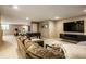Finished basement with a sofa, TV, foosball table, and exercise bike at 12715 Norfolk Ln, Carmel, IN 46032
