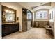 Luxurious bathroom featuring a tiled walk-in shower, custom vanity, and elegant fixtures, designed for comfort and style at 12715 Norfolk Ln, Carmel, IN 46032