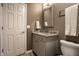 Bathroom featuring gray vanity with marble countertop, toilet, and gray walls at 12715 Norfolk Ln, Carmel, IN 46032