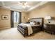 Serene bedroom with tray ceilings, neutral tones, and a large window creating a relaxing retreat at 12715 Norfolk Ln, Carmel, IN 46032