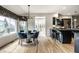 Bright dining area with large windows, a modern chandelier, and access to the kitchen at 12715 Norfolk Ln, Carmel, IN 46032