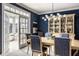 Elegant dining room with blue walls, modern lighting, and built-in china cabinet, perfect for entertaining at 12715 Norfolk Ln, Carmel, IN 46032