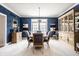 Formal dining room featuring blue walls, classic china cabinet, and abundant natural light, great for gatherings at 12715 Norfolk Ln, Carmel, IN 46032