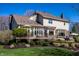 Back exterior of home with deck, sunroom, patio, and lush lawn at 12715 Norfolk Ln, Carmel, IN 46032
