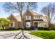 Beautiful brick home with manicured lawn, mature trees, and a curved driveway creating a welcoming entrance at 12715 Norfolk Ln, Carmel, IN 46032