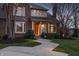 Charming home featuring an inviting entrance with manicured landscaping and a well-lit walkway at 12715 Norfolk Ln, Carmel, IN 46032