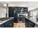 Well-equipped kitchen featuring custom cabinets, stainless steel appliances and a granite countertop island at 12715 Norfolk Ln, Carmel, IN 46032