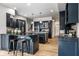 Spacious kitchen with granite countertops, an island with seating, and modern stainless steel appliances at 12715 Norfolk Ln, Carmel, IN 46032