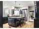 Modern kitchen featuring a central island with seating, custom cabinetry and stainless appliances at 12715 Norfolk Ln, Carmel, IN 46032