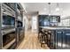 Stylish kitchen with a center island, stainless appliances, and hardwood floors for a modern look at 12715 Norfolk Ln, Carmel, IN 46032