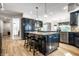 Bright kitchen showcasing a large center island, custom cabinetry, and stainless steel appliances at 12715 Norfolk Ln, Carmel, IN 46032
