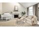 Inviting living room featuring a fireplace, grand piano, and plush seating, ideal for relaxation and entertaining guests at 12715 Norfolk Ln, Carmel, IN 46032
