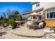 Outdoor patio space with seating, umbrella, and manicured landscaping at 12715 Norfolk Ln, Carmel, IN 46032