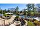 Gorgeous backyard with a pool, spa, waterfall feature, stone patio and fire pit for outdoor enjoyment at 12715 Norfolk Ln, Carmel, IN 46032