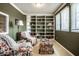 Cozy sitting room with built-in bookshelves, comfortable armchairs, and ample natural light, perfect for relaxation at 12715 Norfolk Ln, Carmel, IN 46032