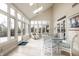 Bright sunroom with white wicker furniture, vaulted ceilings, and lots of natural light at 12715 Norfolk Ln, Carmel, IN 46032