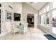 A bright sunroom with vaulted ceiling, a glass table, and wicker furniture at 12715 Norfolk Ln, Carmel, IN 46032