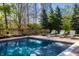Tranquil swimming pool area with lounge chairs for relaxing and enjoying the peaceful backyard setting at 12715 Norfolk Ln, Carmel, IN 46032