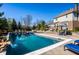 Inviting swimming pool with a rock waterfall feature, surrounded by lounge chairs and lush landscaping at 12715 Norfolk Ln, Carmel, IN 46032