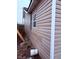 Exterior view of the home showcasing the tan siding and a window at 1309 W Memorial Dr, Muncie, IN 47302