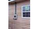 Exterior detail showcasing an electrical box and a window at 1309 W Memorial Dr, Muncie, IN 47302