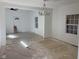 Living room featuring windows, a modern chandelier, fresh paint, and doorway, offering ample space and light at 1309 W Memorial Dr, Muncie, IN 47302