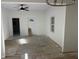 Living room featuring windows, a ceiling fan, fresh paint, and doorway, offering ample space and light at 1309 W Memorial Dr, Muncie, IN 47302