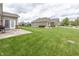 Expansive backyard showcasing a well-kept lawn and a view of the property's exterior and surrounding neighborhood at 14014 Fieldcrest Dr, McCordsville, IN 46055