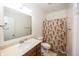Neutral bathroom featuring a modern sink, toilet, and a shower with a decorative floral shower curtain at 14014 Fieldcrest Dr, McCordsville, IN 46055