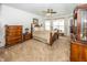 Comfortable bedroom with plush carpeting, a ceiling fan, and ample natural light at 14014 Fieldcrest Dr, McCordsville, IN 46055