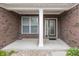Welcoming front porch showcasing brick pillars and decorative glass front door at 14014 Fieldcrest Dr, McCordsville, IN 46055