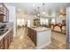 Bright kitchen with stainless steel appliances, granite countertops, and a view of the living room at 14014 Fieldcrest Dr, McCordsville, IN 46055