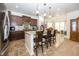 Modern kitchen with dark wood cabinets, granite countertops, and stainless steel appliances at 14014 Fieldcrest Dr, McCordsville, IN 46055