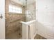 Accessible tiled shower with glass enclosure, grab bar, and rainfall shower head at 14014 Fieldcrest Dr, McCordsville, IN 46055