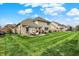 The brick home has a spacious backyard, complete with a pergola-covered patio and green grass at 1611 Connemara Rd, Indianapolis, IN 46217