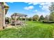 Relax in your backyard with a pergola-covered patio, perfect for outdoor entertaining and grilling at 1611 Connemara Rd, Indianapolis, IN 46217