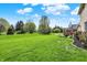 Expansive backyard with lush green grass, mature trees, and privacy, perfect for outdoor activities at 1611 Connemara Rd, Indianapolis, IN 46217